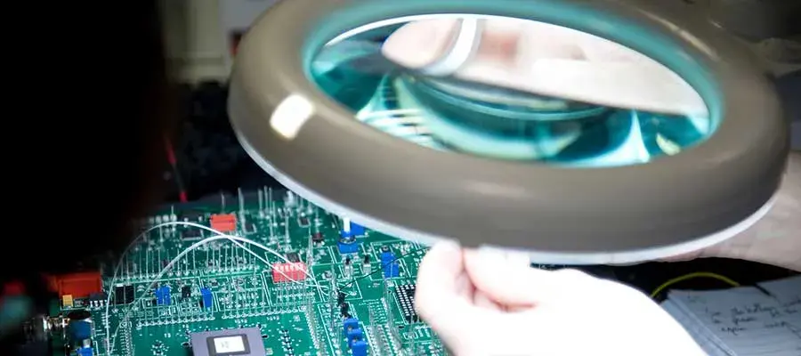 Engineering student working on a circuit board