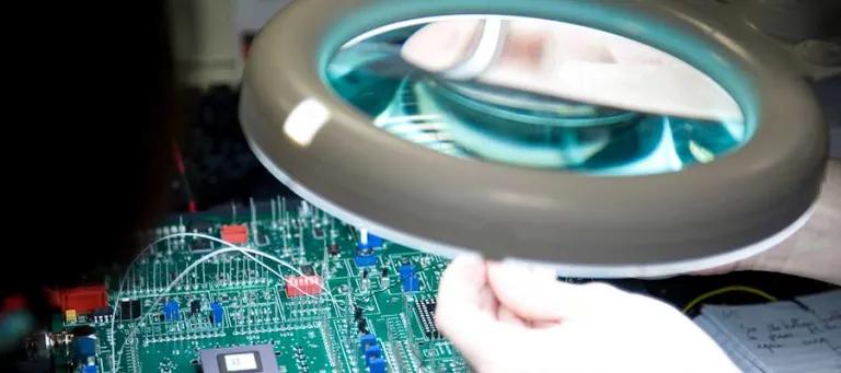 Engineering student working on a circuit board